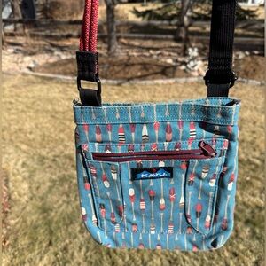 Kavu Keepalong Aqua Blue with Wooden Paddles Oars Red Rope Sling Cross Body